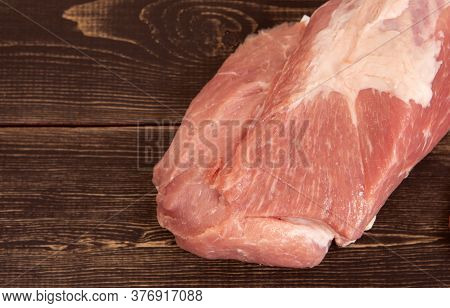 A Large Piece Of Fresh Pork Pulp On A Wooden Surface, Light Background. Ingredient, Meat For Cooking