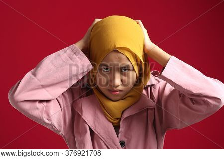 Stress. Young Asian Muslim Teenage Girl Frustrated Holding Hear Head, Woman Wearing Hijab With Angry