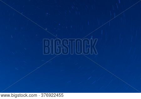 Background Of Round Or Circular Star Track Or Trajectory On The Blue Clear Night Sky. Symbol Of Spac