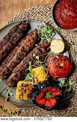Eastern Fast Food. Grilled Beef Lyulya Kebab On Sticks On Plate With Grilled Vegetables Sweet Corn C