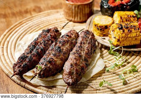 Eastern Fast Food. Grilled Beef Lyulya Kebab On Sticks On Flat Bread With Grilled Vegetables Sweet C