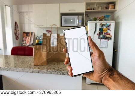 Ordering Food Online In A Mobile, Paper Bah In Background. Space For Text Or Logo.