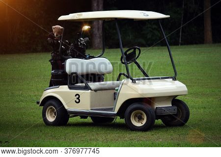 Golfcar In Beautiful Golf Course In The Evening Golf Course With Sunshine In Thailand