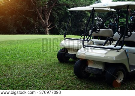 Golfcar In Beautiful Golf Course In The Evening Golf Course With Sunshine In Thailand