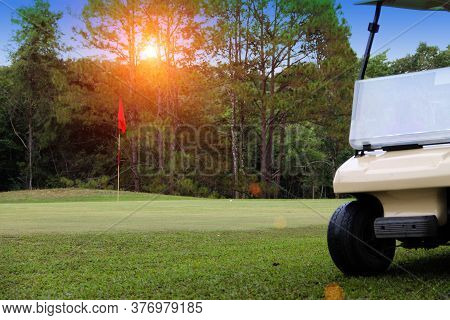 Golfcar In Beautiful Golf Course In The Evening Golf Course With Sunshine In Thailand