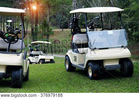 Golfcar In Beautiful Golf Course In The Evening Golf Course With Sunshine In Thailand
