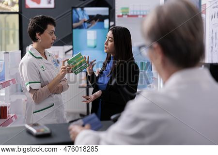 Pharmaceutical Worker Listening To Customer Complaint About Aspiring Medication Near Drugstore Count