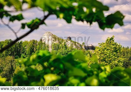 Highland Landscape In Green Scenery. Man Climbing On Jurassic Limestone Rock, Situated Highland Area