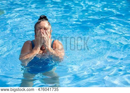 Portrait Of Wonderful Buxom Middle-aged Woman Wearing Blue Swimsuit, Standing In Swimming Pool, Wipi