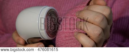 Woman Using Anti-pilling Razor At Home. Device For Shaving Clothes. Anti-plush Fabric Shaver. Electr