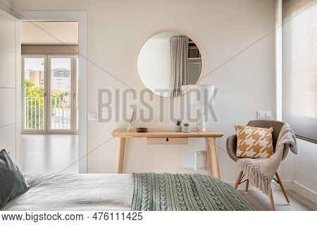 Bedroom In Light Colors With Wooden Eco Furniture And Accessories With A Mirror And A Panoramic Wind