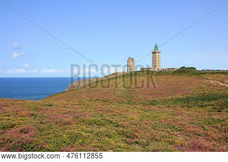 Old Lighthouse And Meadow Full Of Flowers At Cap Frehel, Brittany.
