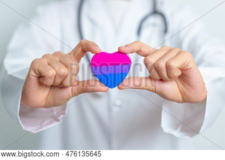 Bisexuality Celebrate Day And Lgbt Pride Month,  Lgbtq+ Or Lgbtqia+ Concept. Doctor Holding Purple, 