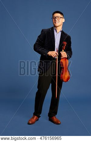 Portrait With Stunning, Young Musicians, Violinist Wearing Elegant Suit And Eyeglasses Holding Music