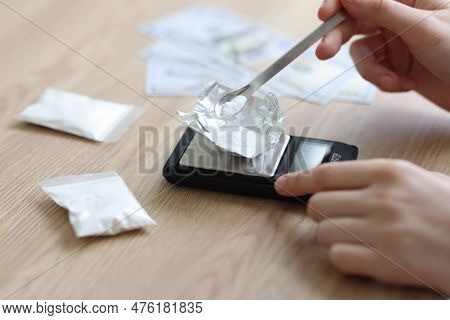 Female Hands Weigh White Powder On Sheet Of Foil On Electronic Scales. Supposedly Narcotics In Trans