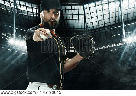 Baseball Player With Grand Arena. Ballplayer On Dark Background In Action.