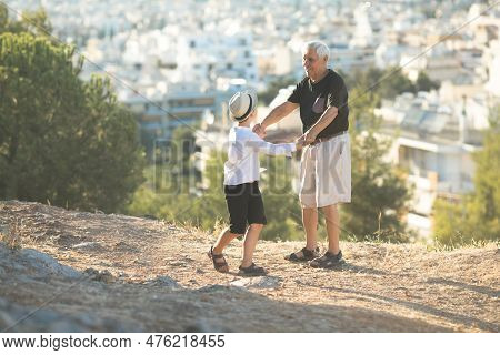 Old And Young. Family Generation And Relations Concept. Retired Grandfather And Grandson Playing Wit