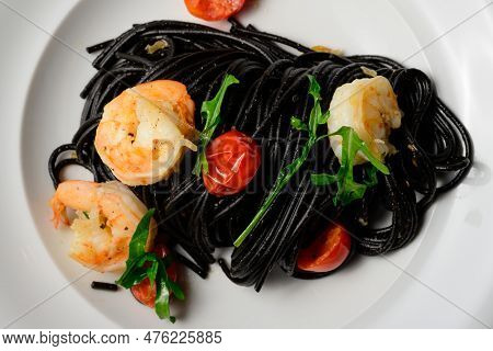 Spaghetti Al Nero Di Seppia Con Gamberi, Italian Pasta With Squid Ink, Prawns, Tomato And Rucola