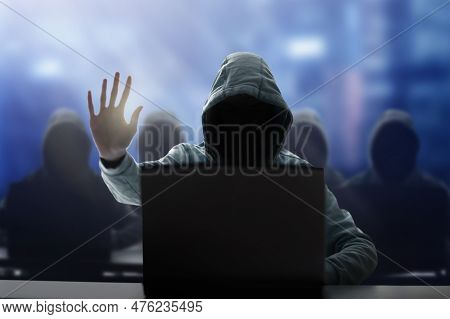 Hacker At Laptop. Malware And Virus Danger. Man In Hoodie And Dark Mask Hacking. Dark Net And Cyber 