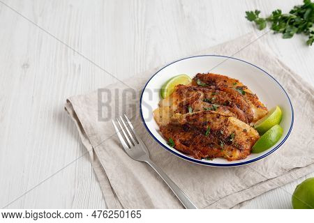 Homemade Pan Seared Tilapia On A Plate, Side View. Copy Space.