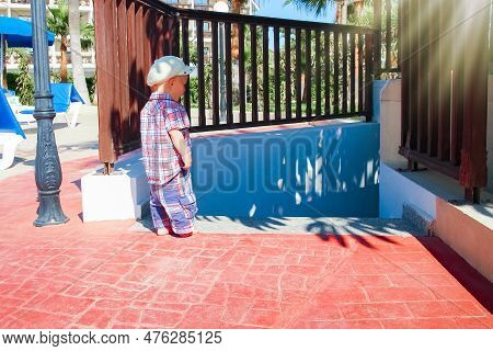 A Happy Child Plays By The Pool On The Nature By The Sea