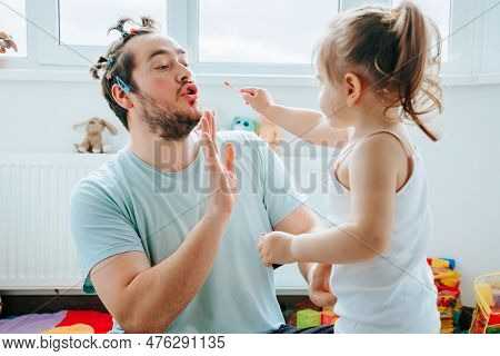 A Fynny Dad And His Child Enjoying A Hilarious And Memorable Makeup Session, With Both Of Them Havin