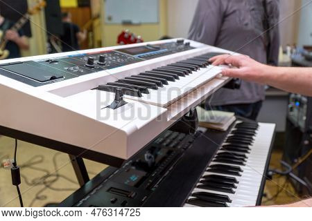 A Pianist Or Keyboardist Plays A Synthesizer