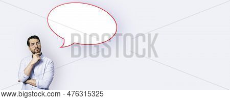 Attractive Young European Businesswoman With Speech Bubble On Wide White Background. Opinion, Speech