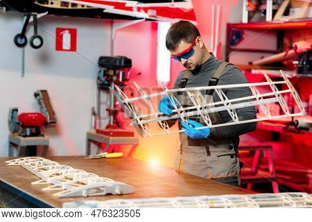 Expert Male Engineer Or Technician Working On Drone Details In Lab. Aircraft Capable Of Gps Surveill