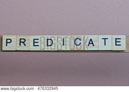 Gray Word Predicate Made Of Wooden Square Letters On Brown Background
