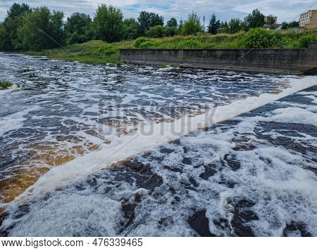 Dirty Brown Foamy Water In The River Nevezis City Panevezys Of Lithuania City Dam