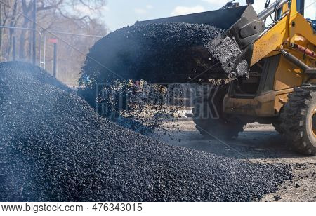 Asphalt Paver Filled With Hot Tarmac Laying New Road Surface On New Residential Housing Development 