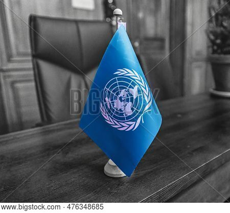 The Hague, Netherlands - December 15 2022: A Blue United Nations Flag Is Standing On A Desk Of An Of