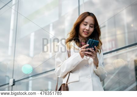 Portrait Successful Business Woman Smiling Holding Smartphone Using App Chat Online In Morning, Asia