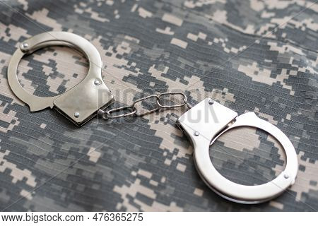 A Military Camouflage, Handcuffed. Concept: War Criminal, Prisoner Of War, Tribunal For Deserters, T