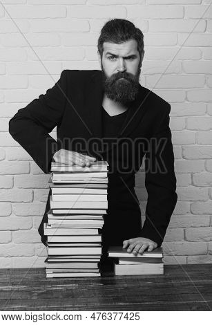 Serious Teacher Or Professor With Book Stack. Thinking Serious Mature Teacher. Mature Professor, Mid