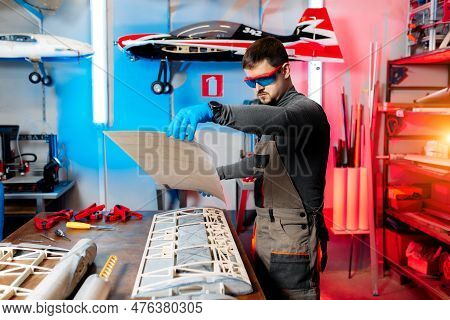 Male Engineer Or Technician Working On Drone Details In Lab. Aircraft Capable Of Gps Surveillance. C