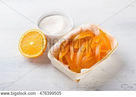 Wicker Birch Basket With Fresh Juicy Candied Oranges With Fresh Juicy Orange And Sugar On A Light Gr