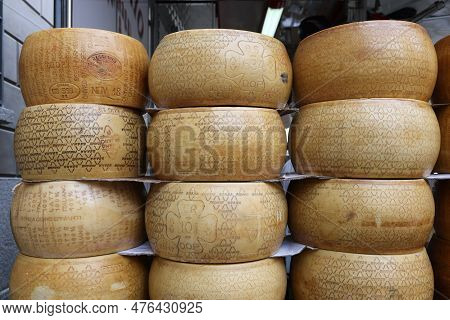 Cremona, Italy - September 7, 2022: Whole Wheels Of Parmigiano Reggiano Cheese Sold At A Street Stal