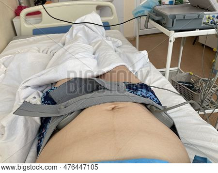 Cardiotocography. Pregnant Woman On Hospital Couch During Medical Control Cardiotocography.