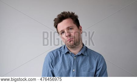 The Angry European Young Man Wearily Looks. He Is Without Strength And Energy