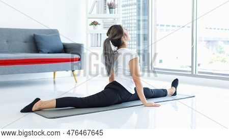 Asian Beautiful Healthy Fit Slim Sexy Female Sporty Athlete Model In Sportswear And Leggings Sitting