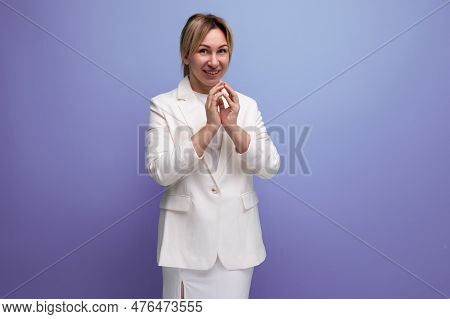 Pretty Young Blond Career Woman In White Elegant Jacket And Skirt Smiling