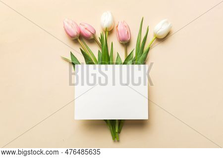 Composition With Blank Card And Beautiful Flowers Tulip On Coloredbackground. Top View With Space Fo