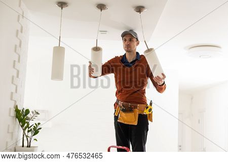 Electrician Man Working On Exterior Light, Install Led Replacement Lamp At Home. Maintenance Concept