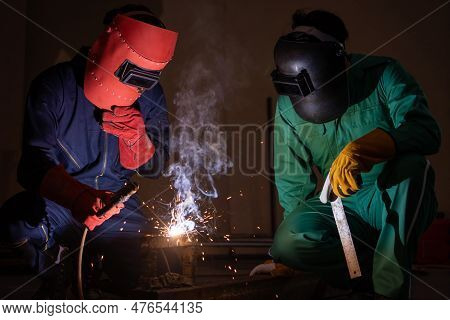 Metal Welding Steel Works Using Electric Arc Welding Machine To Weld Steel At Factory. Metalwork Man