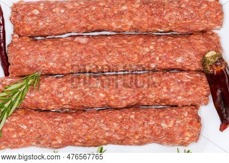Several Raw Lula Kebab On Dish Among The Some Spices, Fragment Top View