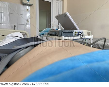 Cardiotocography. Pregnant Woman On Hospital Couch During Medical Control Cardiotocography.