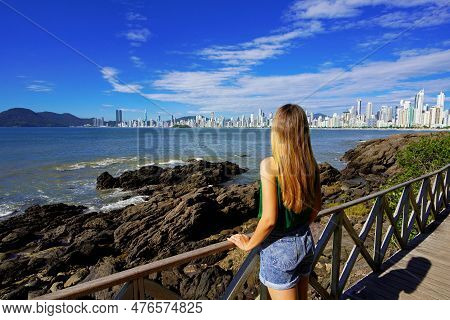 Vacation In Balneario Camboriu, Brazil. Beautiful Girl Enjoying View Of Balneario Camboriu Skyline O