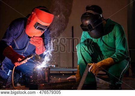 Metal Welding Steel Works Using Electric Arc Welding Machine To Weld Steel At Factory. Metalwork Man